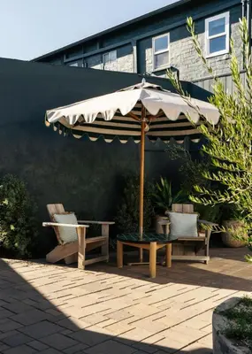 a patio with an umbrella and two chairs and a table at Le Petit Pali Brentwood in Los Angeles