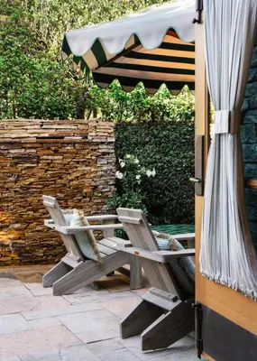 a patio with two chairs and an umbrella at Le Petit Pali Brentwood in Los Angeles