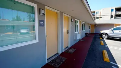 a hallway of a building with a car parked on the street at El Royale Gardens Near Universal Studios in Los Angeles