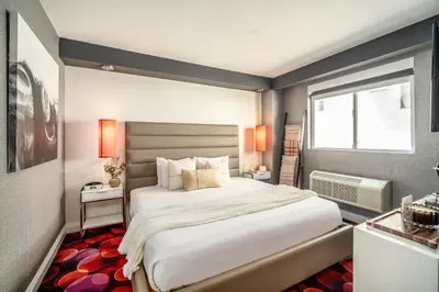 a bedroom with a large bed and a window at Lexen Hotel - Hollywood Walk of Fame-Universal Studios in Los Angeles
