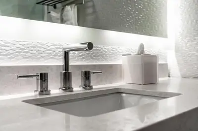 a bathroom sink with a faucet and a soap dispenser at Lexen Hotel - Hollywood Walk of Fame-Universal Studios in Los Angeles