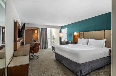 a hotel room with a large bed and a desk at Holiday Inn Oxnard - Ventura by IHG in Oxnard