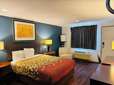 a hotel room with a bed and a desk at Baymont by Wyndham Bakersfield in Bakersfield