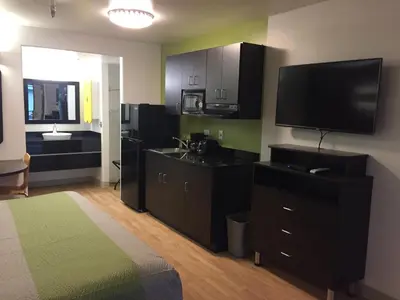 a room with a kitchen with a television and a bed at Studio 6 Victorville - Apple Valley in Victorville