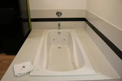a bath tub in a bathroom with a sink at Studio 6 Victorville - Apple Valley in Victorville
