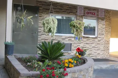 a flower garden in front of a building at Florentina Motel - Los Angeles in Los Angeles