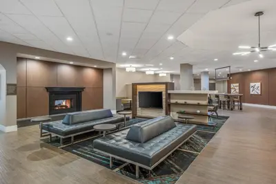 a lobby with leather couches and a fireplace at Staybridge Suites Oxnard - River Ridge by IHG in Oxnard