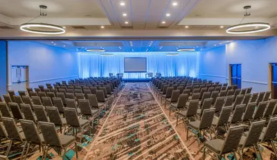 an empty room with chairs and a screen at Staybridge Suites Oxnard - River Ridge by IHG in Oxnard