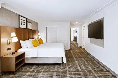 a hotel room with a bed and a flat screen tv at Staybridge Suites Oxnard - River Ridge by IHG in Oxnard