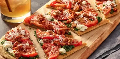 a group of pizzas on a wooden cutting board at Courtyard by Marriott Riverside UCR/Moreno Valley Area in Riverside
