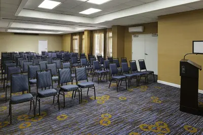 a large room with chairs and a podium in it at Courtyard by Marriott Riverside UCR/Moreno Valley Area in Riverside