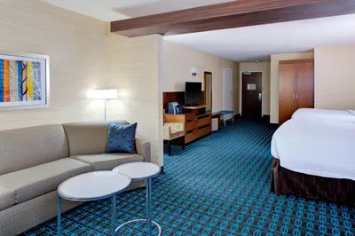 a hotel room with a bed and a couch at Fairfield Inn & Suites by Marriott Bakersfield North/Airport in Bakersfield