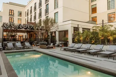 a hotel pool with lounge chairs and a building at Kimpton La Peer Hotel West Hollywood by IHG in Los Angeles