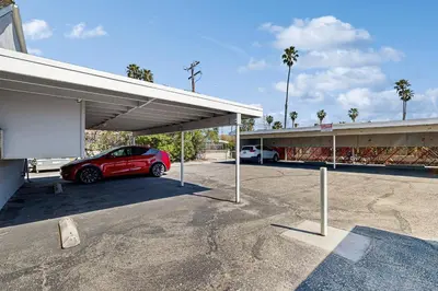 a red car is parked in a parking lot at Sugar Shack in Carpinteria