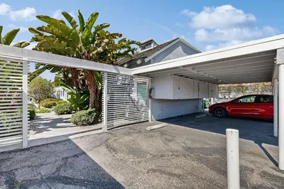 a garage with a car parked in front of a house at Sugar Shack in Carpinteria