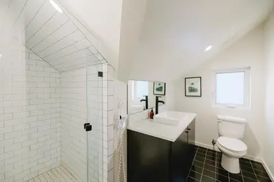 a white bathroom with a sink and a toilet at Noon on Sunset Hill in Los Angeles