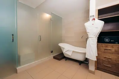 a bathroom with a bath tub and a shower at The Cove Hotel in Long Beach