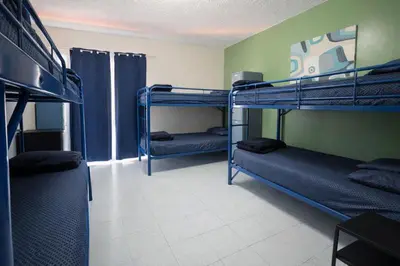 a room with three bunk beds in a room at Banana Bungalow West Hollywood Hotel & Hostel in Los Angeles