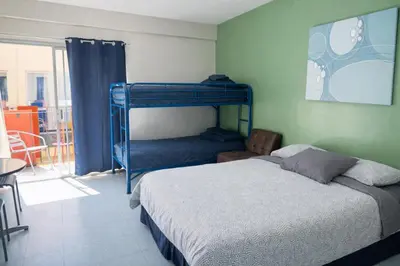 a bedroom with two bunk beds and a balcony at Banana Bungalow West Hollywood Hotel & Hostel in Los Angeles