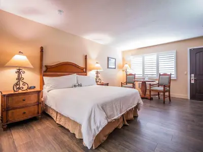 a bedroom with a bed and a table and chairs at Casa Ojai Inn in Ojai