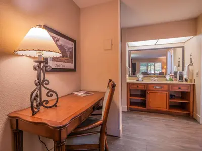 a room with a desk with a lamp and a sink at Casa Ojai Inn in Ojai