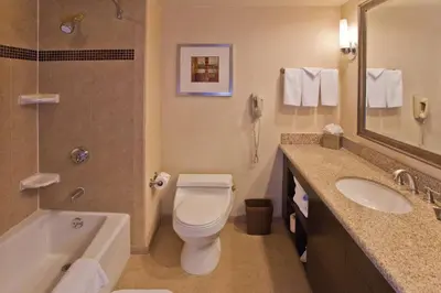 a bathroom with a toilet and a sink and a shower at DoubleTree by Hilton Rosemead in Rosemead