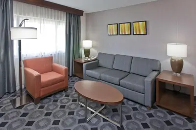 a living room with a couch and a chair at DoubleTree by Hilton Rosemead in Rosemead
