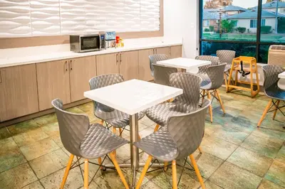 a restaurant with tables and chairs and a counter at Gateway Inn Gardena Los Angeles South in Gardena