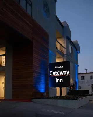 a sign for a car dealership in front of a building at Gateway Inn Gardena Los Angeles South in Gardena