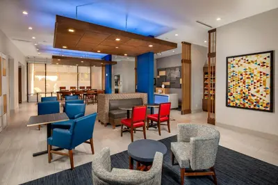a lobby with chairs and tables and a dining area at Holiday Inn Express & Suites Chatsworth by IHG in Chatsworth