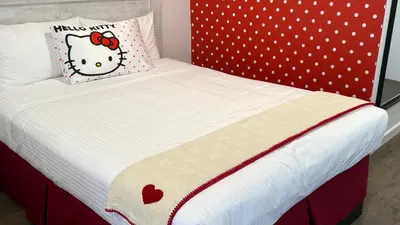 a bed with a hello kitty pillow on it at The Dixie Hollywood in Los Angeles
