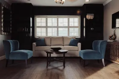 a living room with a couch and two chairs and a table at The Dixie Hollywood in Los Angeles