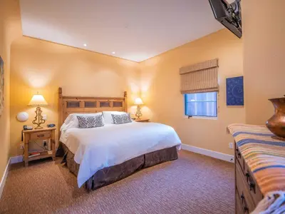 a bedroom with a large bed and a window at Su Nido Inn in Ojai