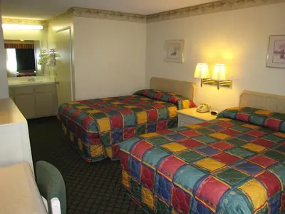a hotel room with two beds and a bathroom at Town House Motel in Lancaster
