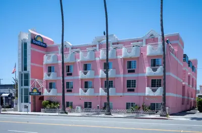 a pink building on the side of a street at Days Inn by Wyndham Santa Monica in Los Angeles