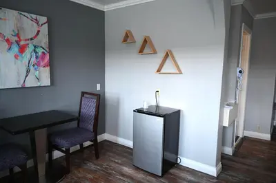 a room with a table and a chair and a wall at Hollywood Stars Inn in Los Angeles