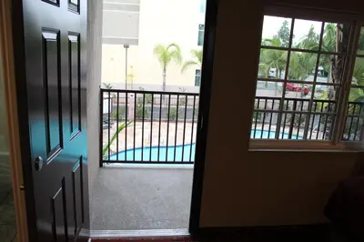 an open door to a balcony with a view of a pool at Budget Inn Anaheim near Disneyland Drive in Anaheim