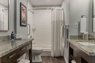 a bathroom with a toilet and a shower and a sink at Club Wyndham Dolphin's Cove in Anaheim