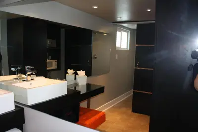 a bathroom with a white sink and a mirror at Hotel Current in Long Beach