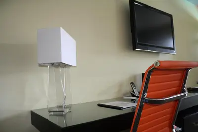 a room with a desk with a television and a chair at Hotel Current in Long Beach
