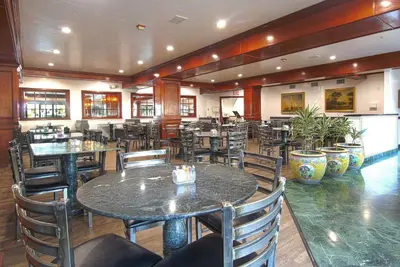 a dining room with tables and chairs in a restaurant at Azure Hotel&Suites Ontario Trademark Collection by Wyndham in Ontario