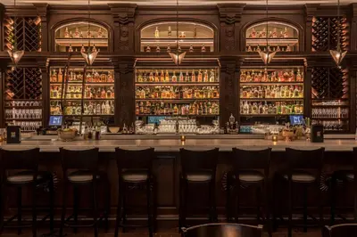 a bar at a restaurant with bar stools at Hollywood Historic Hotel in Los Angeles