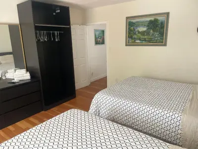 a bedroom with two beds and a dresser at The Village in North Hollywood