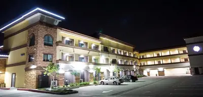 a building with a car parked in front of it at Hartford Hotel Best Western Signature Collection in Rosemead