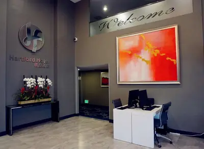 an office with a desk with a computer on a wall at Hartford Hotel Best Western Signature Collection in Rosemead