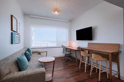 a living room with a couch and a table at Element Palmdale in Palmdale