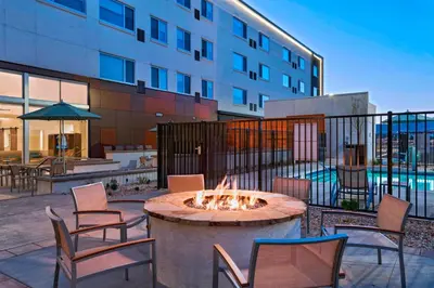 a fire pit in a patio in front of a building at Element Palmdale in Palmdale