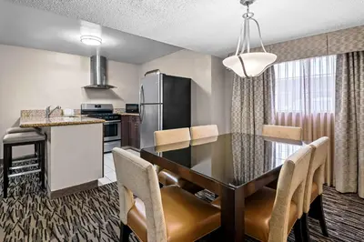 a kitchen and dining room with a table and chairs at Best Western Los Alamitos Inn & Suites in Los Alamitos
