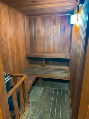 a wooden sauna with a wooden bench in it at Wave Hotel Manhattan Beach in Manhattan Beach