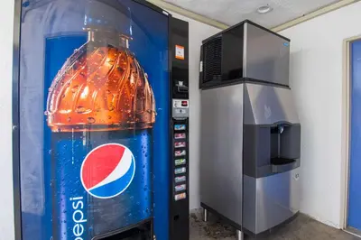 a coca cola bottle next to a soda machine at Motel 6-San Bernardino, CA - Downtown in San Bernardino